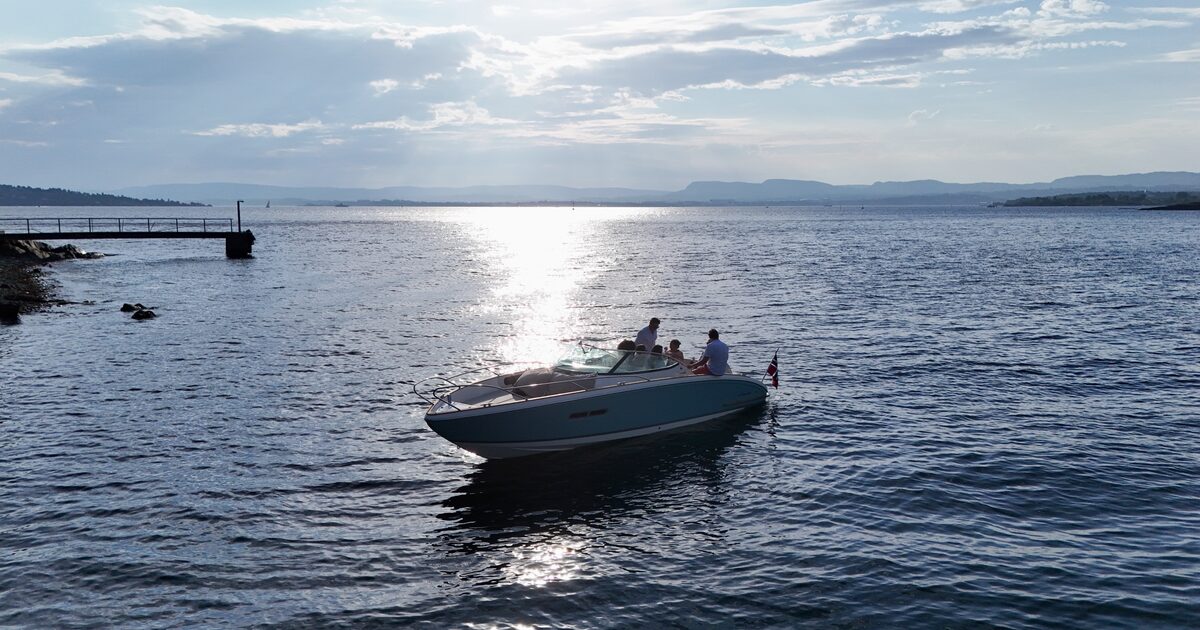 The boat lying calm beside a jetty in silver evening light
