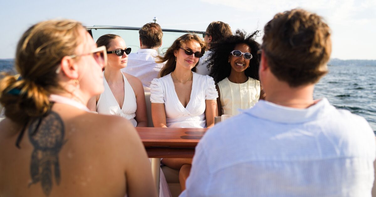 A team gathered around the teak table on deck
