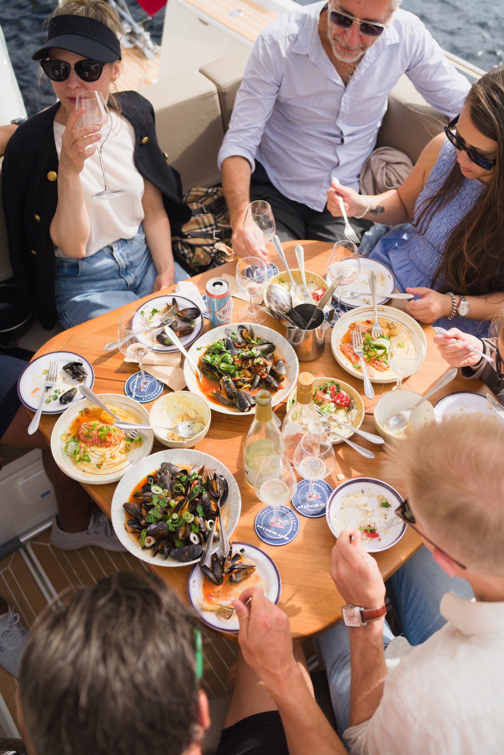 A seafood lunch laid out on the teak table on board