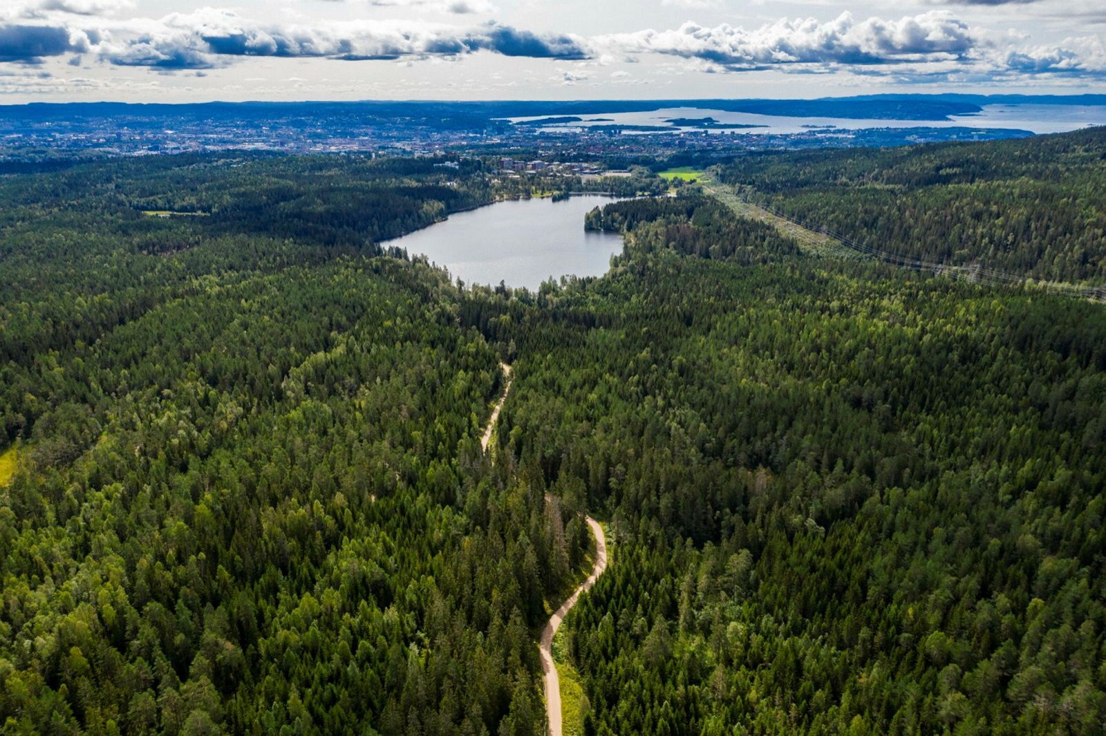 The forest road through Nordmarka, Sognsvann, the city and the fjord beyond